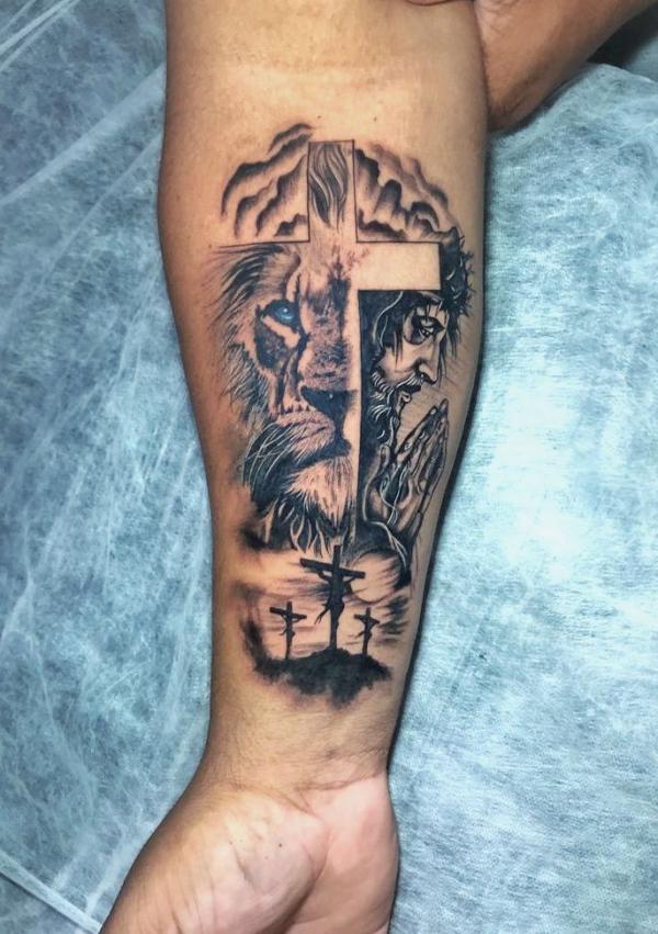 Cross lion and Jesus with praying hands tattoo forearm