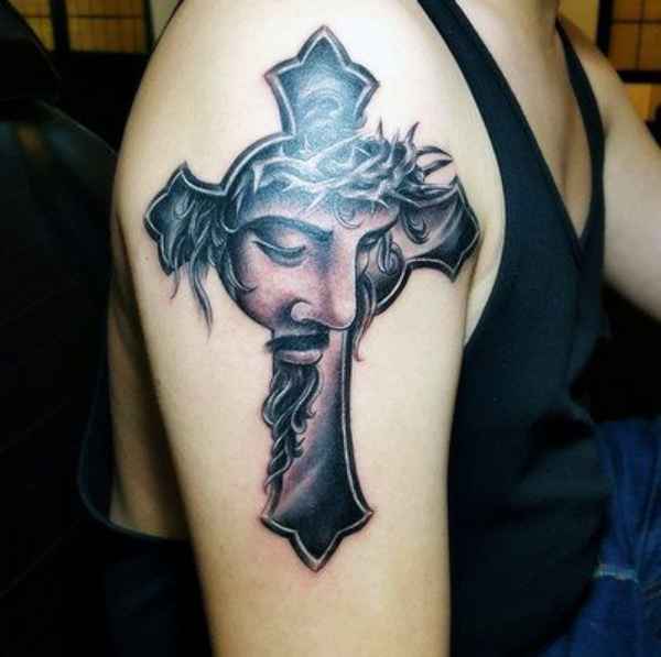 Cross tattoo with jesus face on upper arm