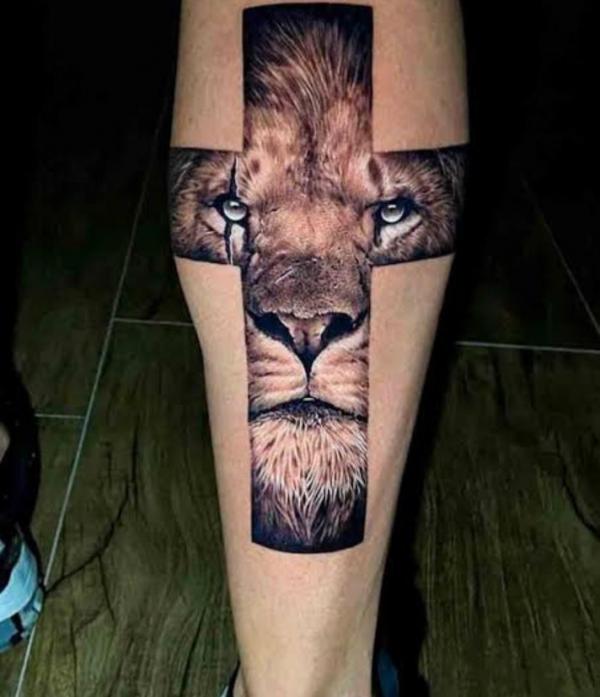 Cross with lion face calf tattoo