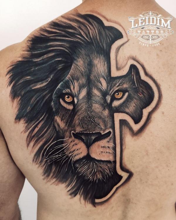 Cross with lion king back tattoo