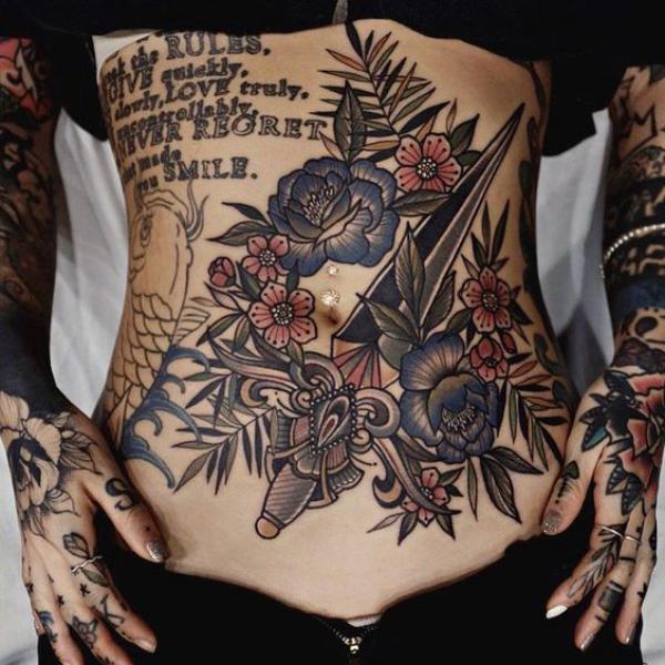 Dagger with flowers stomach tattoo