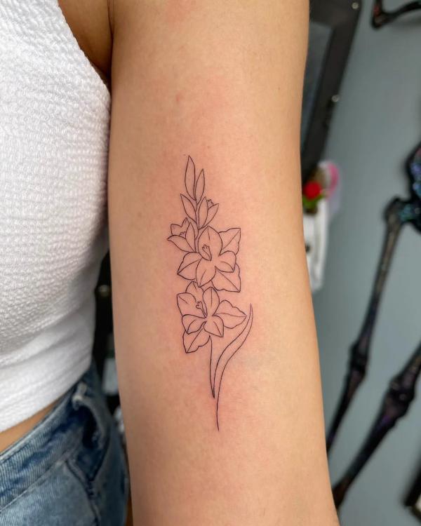 Dainty gladiolus outline tattoo