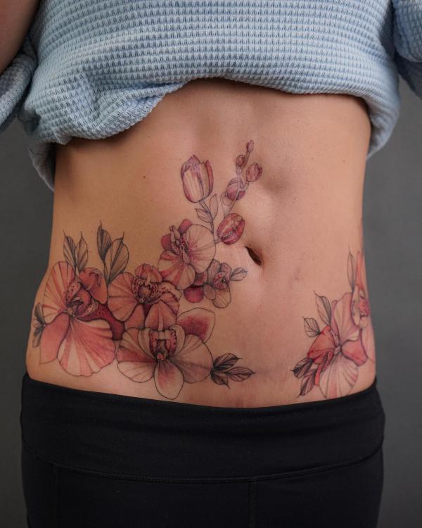 Dainty orchid stomach tattoo