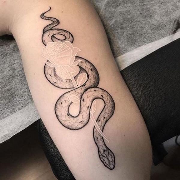Dainty rose interwined with a white ink rose tattoo