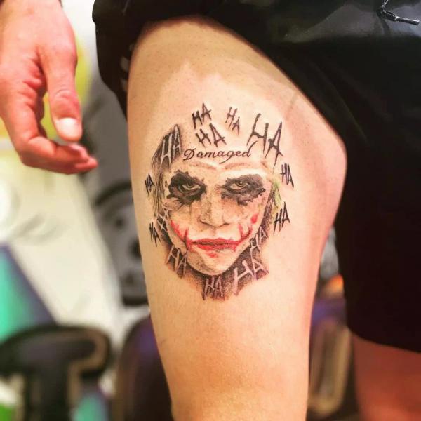 Damaged Joker hahaha thigh tattoo