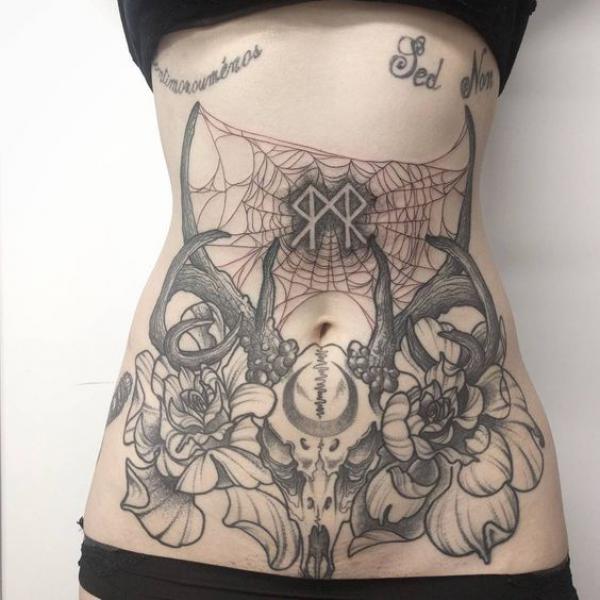 Deer skull with flowers and spider web stomach tattoo