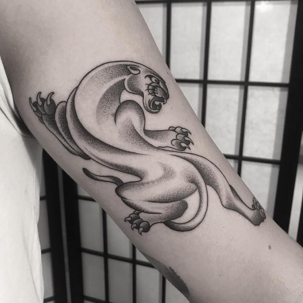 Dotwork crawling panther tattoo on arm