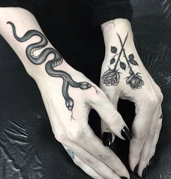 Doube head snake and crossed rose hand tattoo