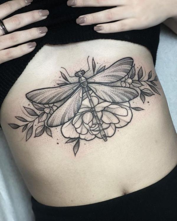 Dragonfly and flower stomach tattoo black and grey