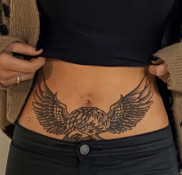 Eager spreading wings tummy tattooo