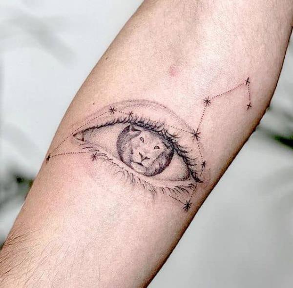 Eye with lion and leo constellation tattoo
