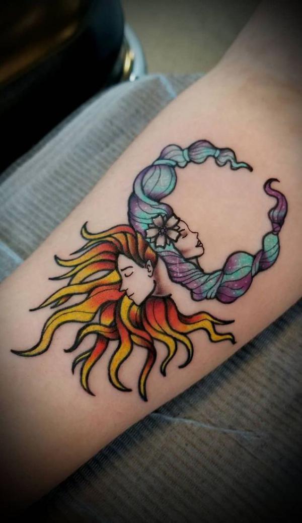 Female face sun and moon tattoo