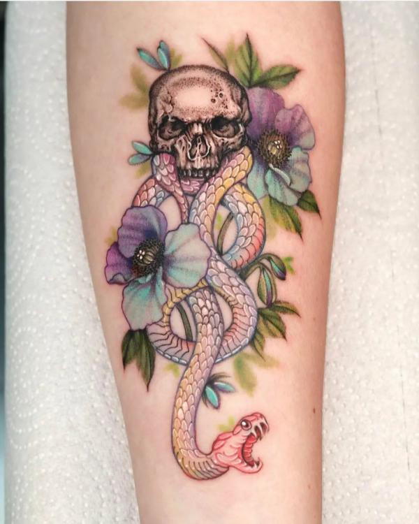 Feminine death eater with flowers tattoo