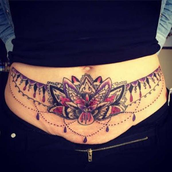 Feminine lotus tummy tattoo
