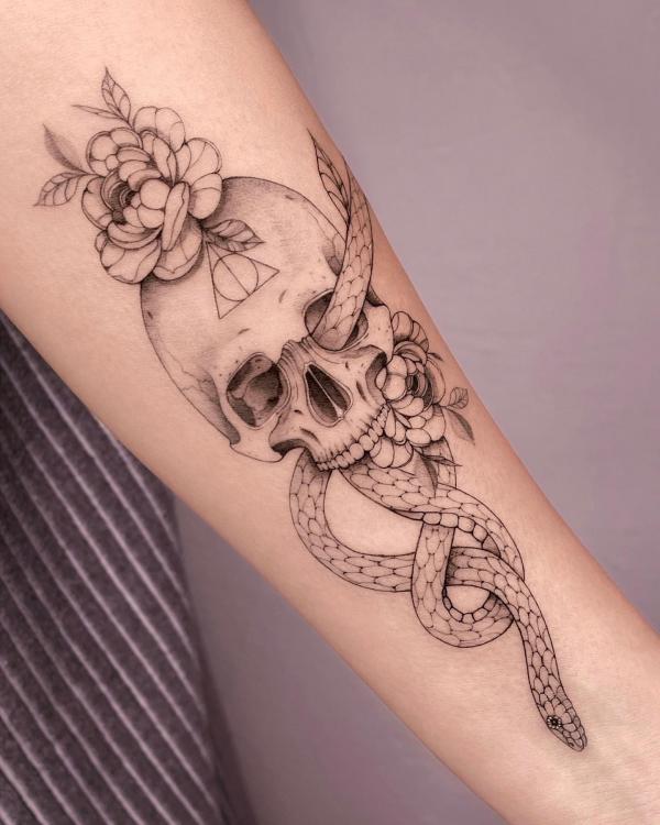 Fine line death eater with flower tattoo
