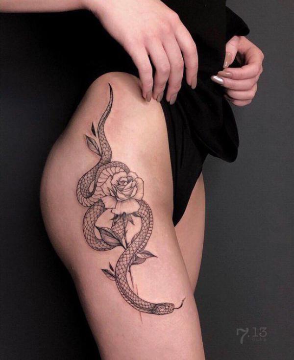 Fine line rose and snake side hip tattoo