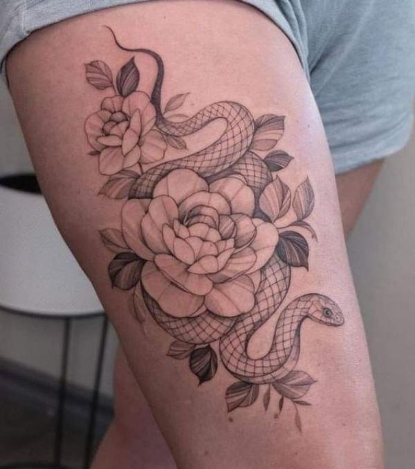 Fine line rose and snake thigh tattoo