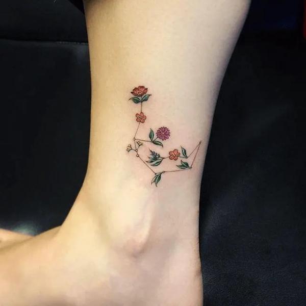 Floral Aries constellation ankle tattoo