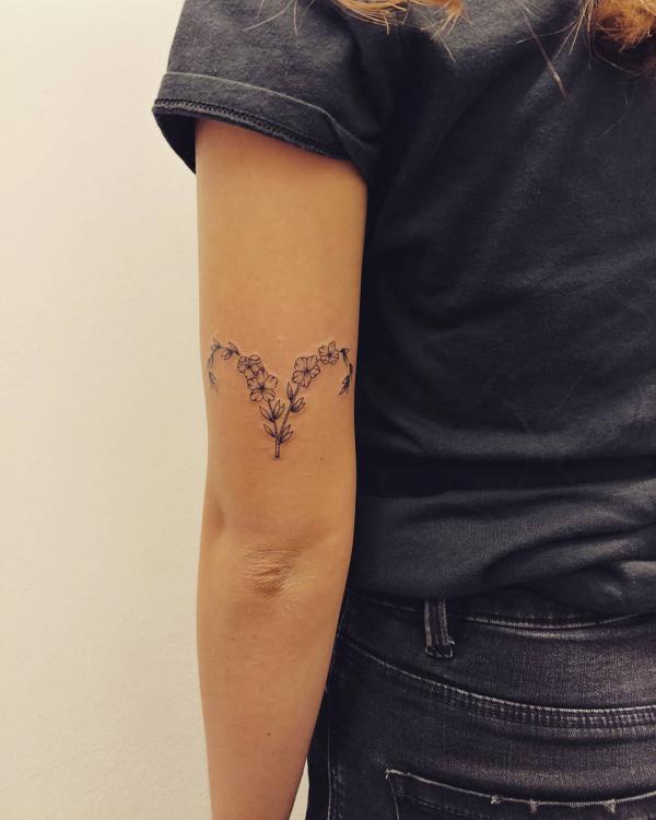 Floral Aries glyph tattoo tattoo above elbow