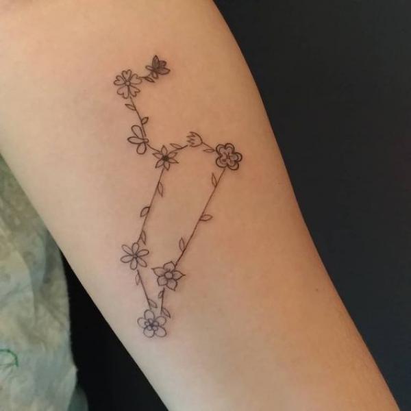 Floral Leo constellation arm tattoo