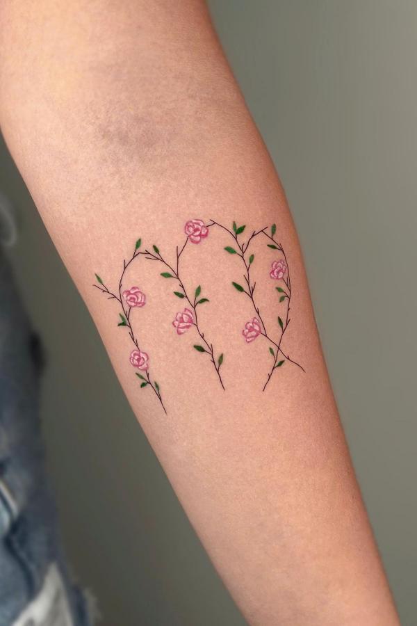 Floral Virgo glyph tattoo on forearm