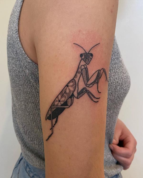 Floral praying mantis upper arm tattoo