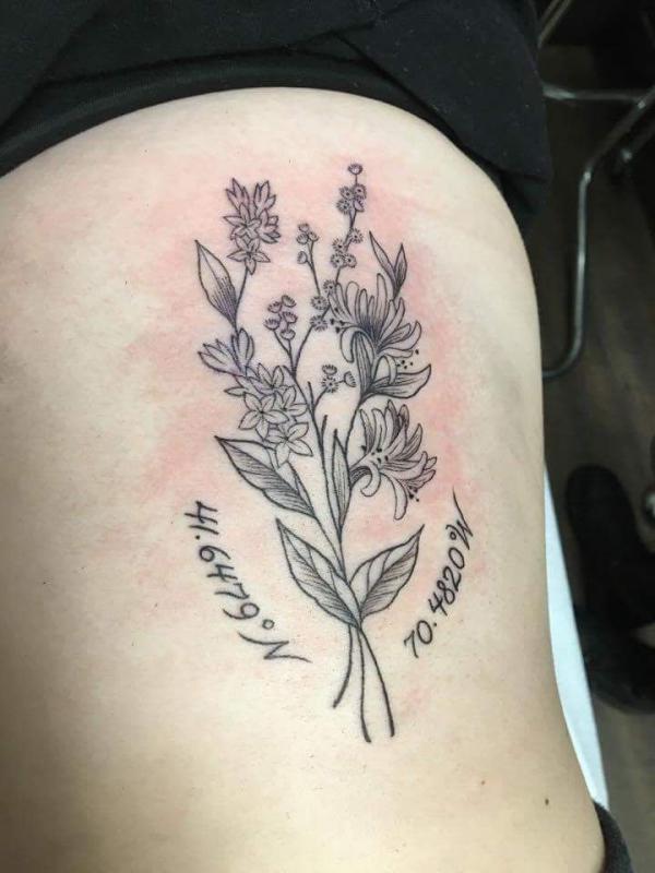 Flower tattoo with coordinates tattoo on rib cage