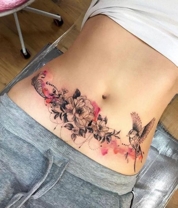 Flowers and bird tummy tattoo