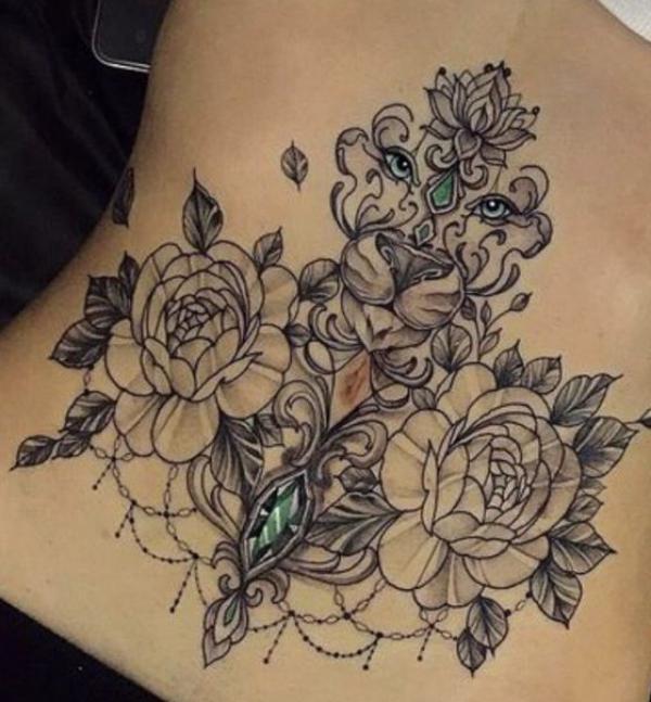 Flowers with eyes abdomen tattoo