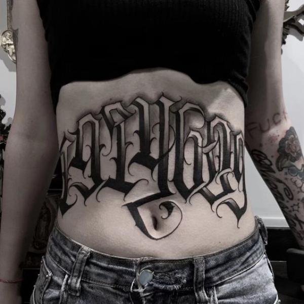 Font lettering stomach tattoo