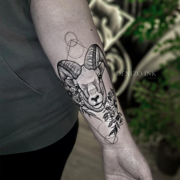 Geometric Aries ram and daisy flower tattoo