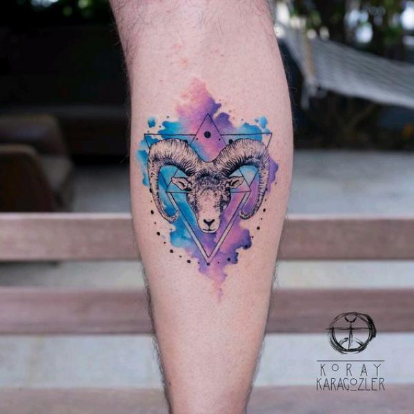 Geometric Aries ram calf tattoo on watercolor backdrop
