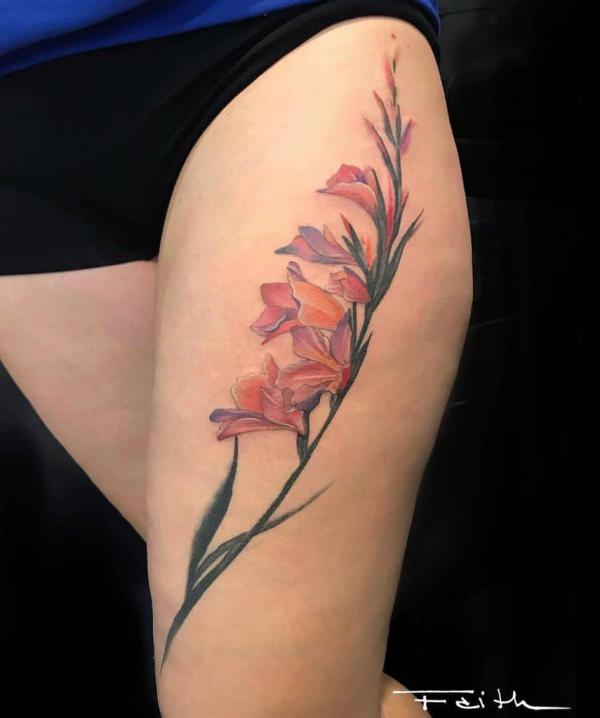 Gladiolus flower thigh tattoo