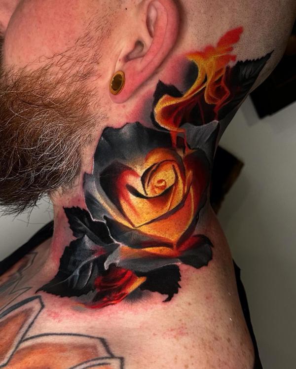 Glowing yellow rose tattoo on neck