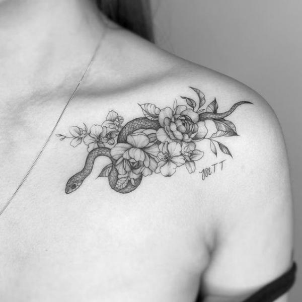 Greyscale rose and snake clavicle tattoo
