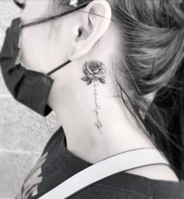 Greyscale rose with cursive words stem tattoo