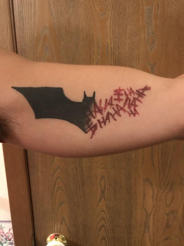 Hahaha joker bicep tattoo