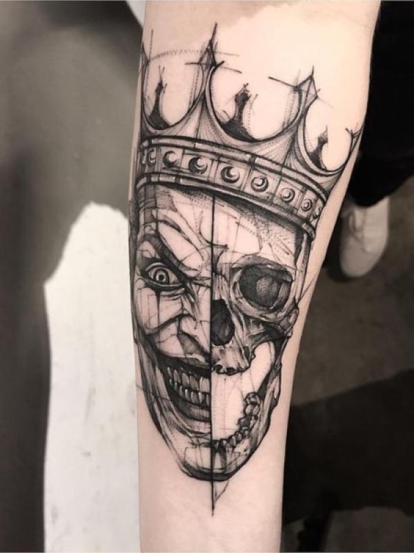 Half Joker half skull king with crown tattoo