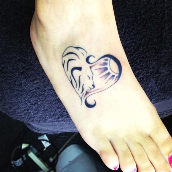 Half Leo lion and half sun heart foot tattoo