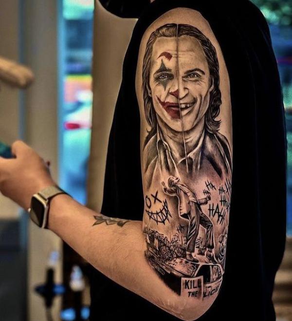 Half smile and half sad joker half sleeve tattoo