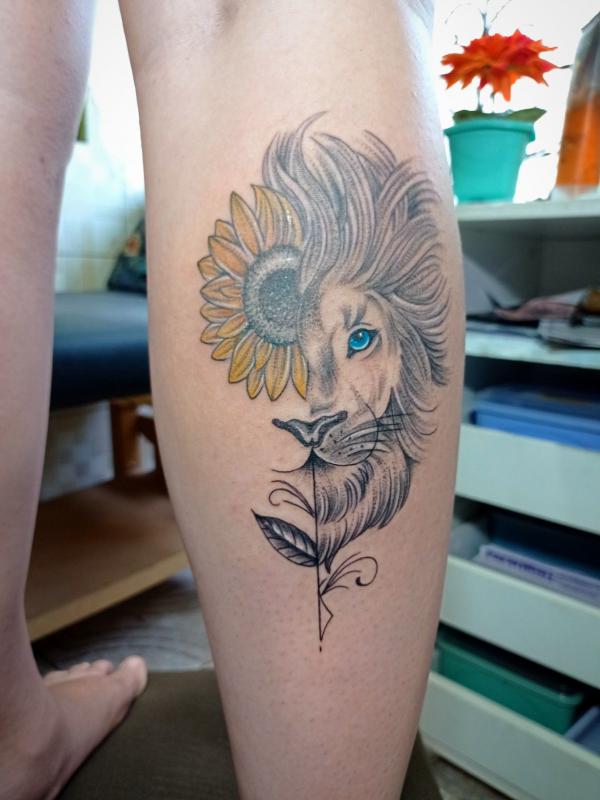 Half sunflower half Leo lion calf tattoo