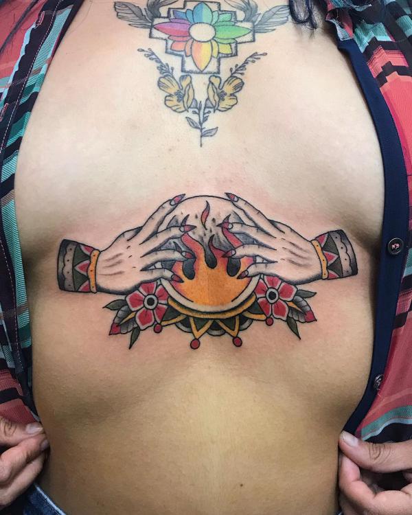 Hands with firing crystal ball abdomen tattoo