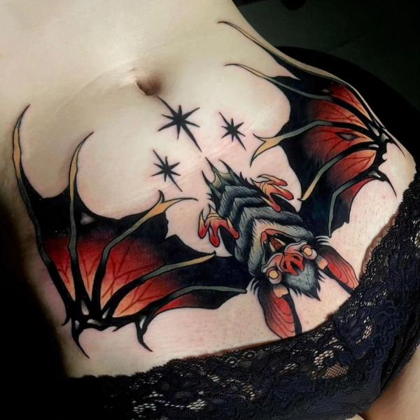 Hanging bat stomach tattoo