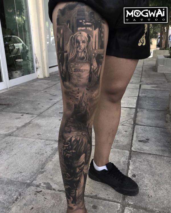 Harley Quinn chewing bubble gum and Joker leg tattoo dark style