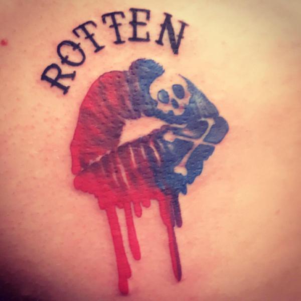 Harley Quinn lips with crossbone skull and the word Rotten tattoo