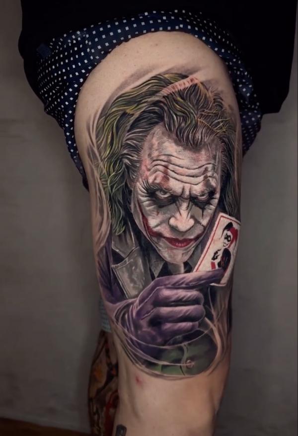 Heath Ledger joker holding a card thigh tattoo