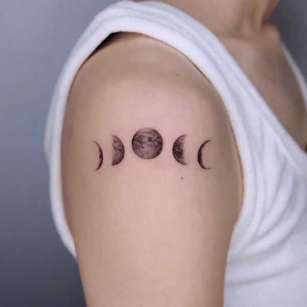 Horizontal moon phases shoulder tattoo