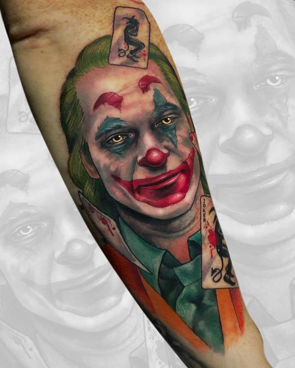 Joaquin Phoenix joker with cards tattoo