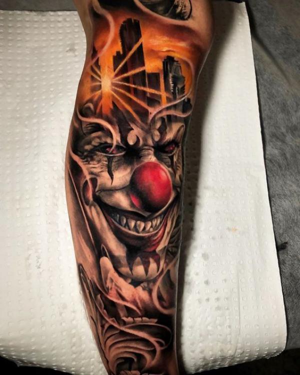 Joker and city lower leg tattoo