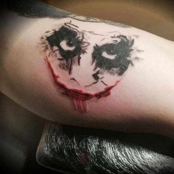 Joker eyes and mouth tattoo